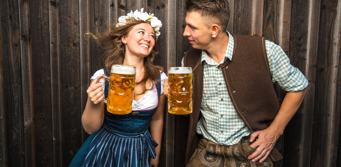 A man and a woman holding Oktoberfest mugs.