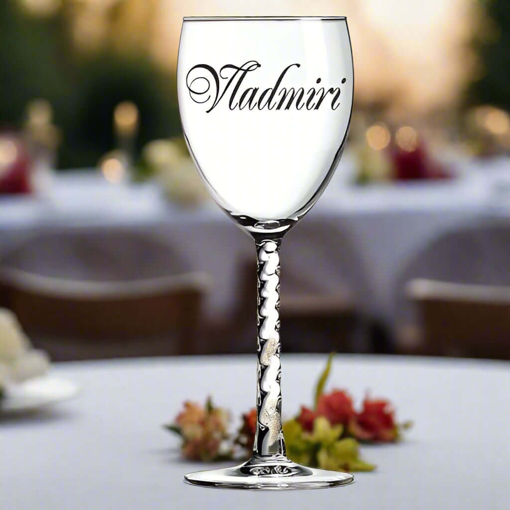 Personalized 10.5 oz wine glass with elegant design and custom name on a table at a dining event.