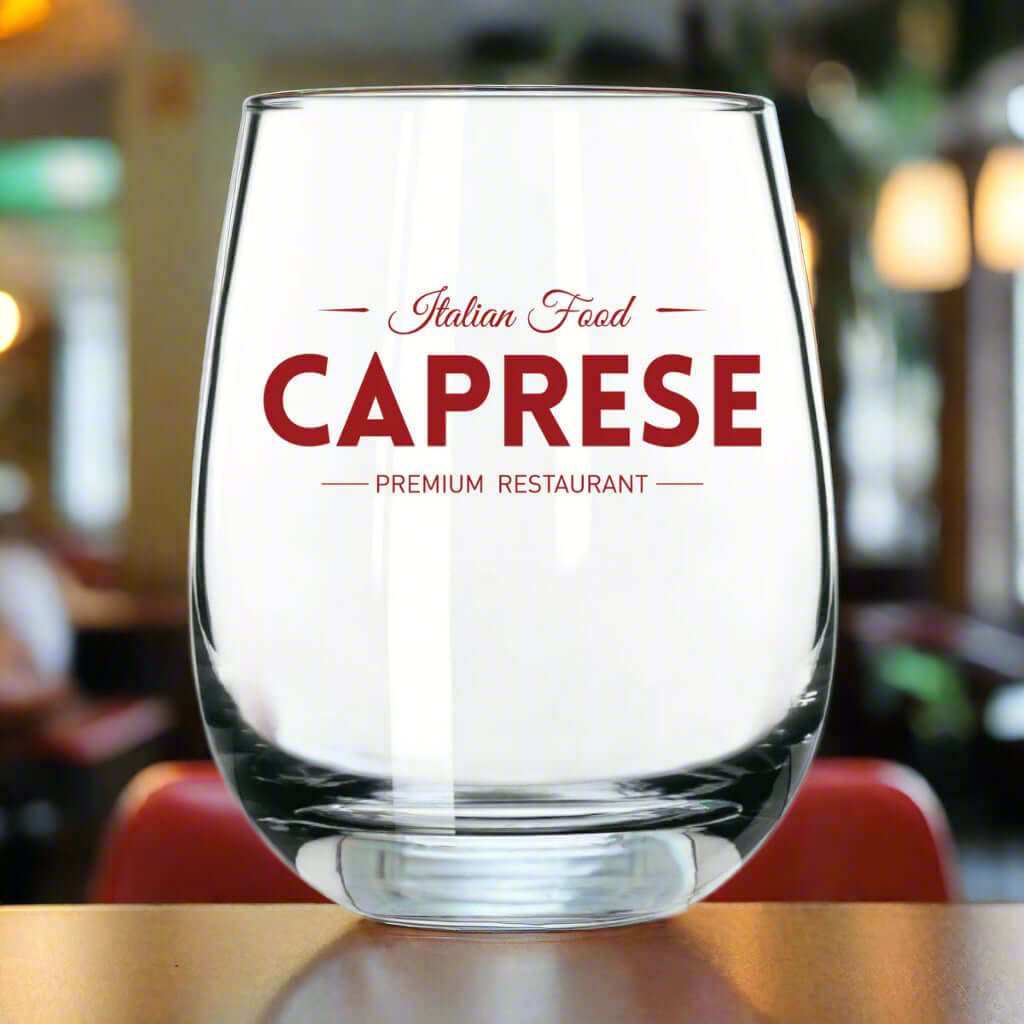Custom stemless wine glass with 'Caprese Premium Restaurant' branding, showcasing elegance for events.