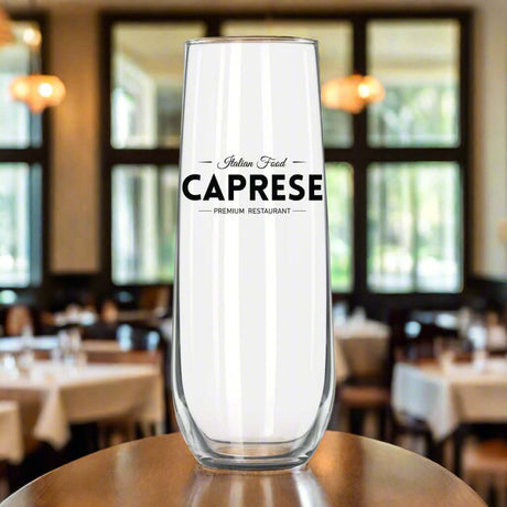 Custom Libbey stemless flute with 'Caprese Premium Restaurant' logo, set in an elegant dining environment.
